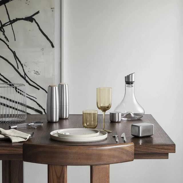 Moderne Blomus Butterdose BASIC aus mattem Edelstahl auf einem elegant gedeckten Holztisch neben Design-Gläsern und Karaffe